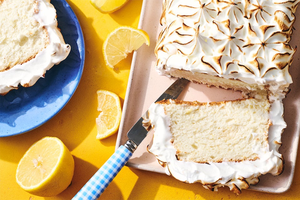 Lemon Angel Food Cake with Meringue Topping sliced on a serving tray