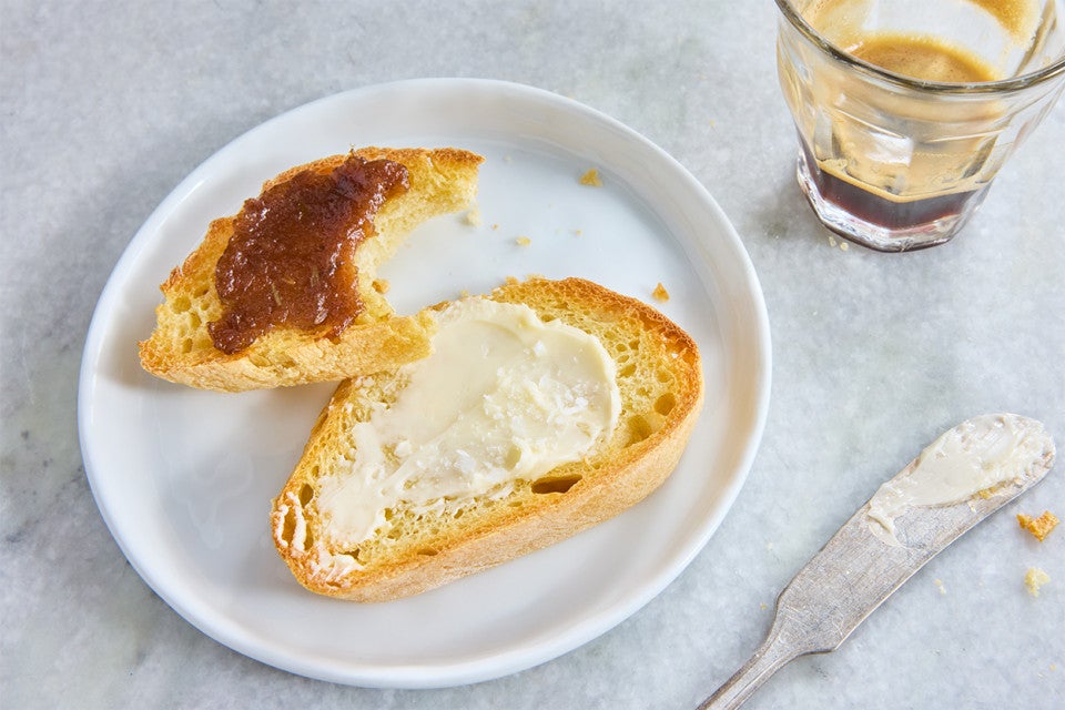 Semolina Baguette sliced on a plate and topped with butter and jam