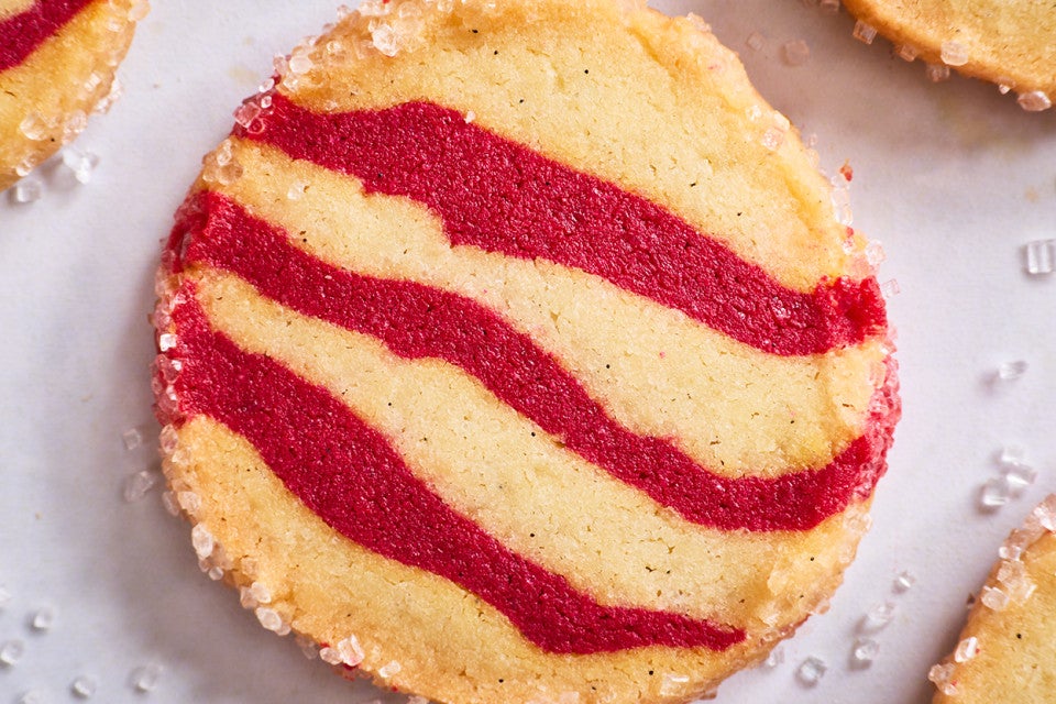 Photograph of a single striped shortbread peppermint cookie from the top.