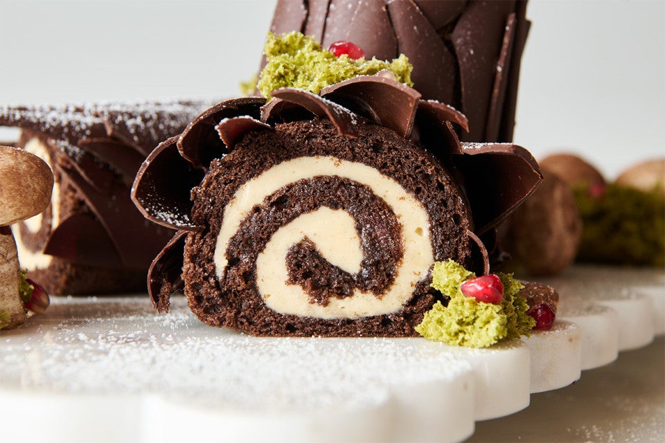 Side view of buche de noel filled with Cookie Butter Whipped Ganache showing a beautiful pinwheel style bake.
