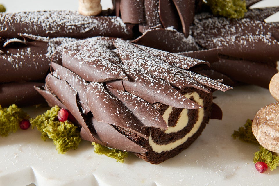 Detailed side view photograph of Chocolate Buche de Noel with Cookie Butter Whipped Ganache.