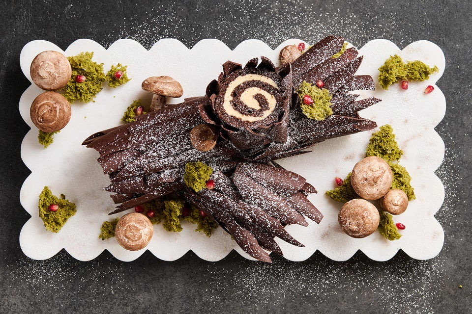 Chocolate Buche de Noel with Cookie Butter Whipped Ganache showing beautiful layers of chocolate coated cake and edible decorations in the style of a log.