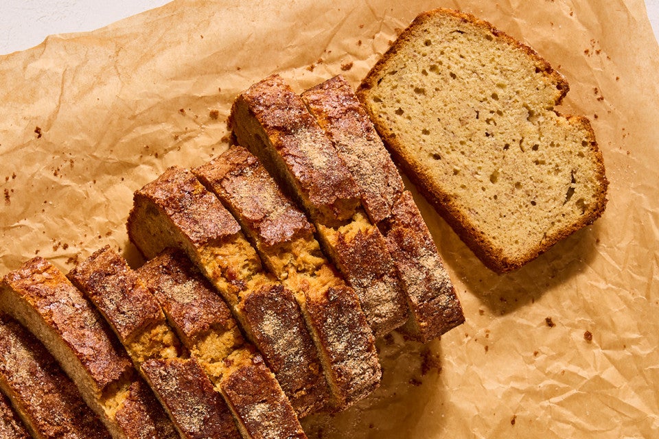A sliced loaf of High-Altitude Banana Bread photographed from above showing one slice laid on its side.