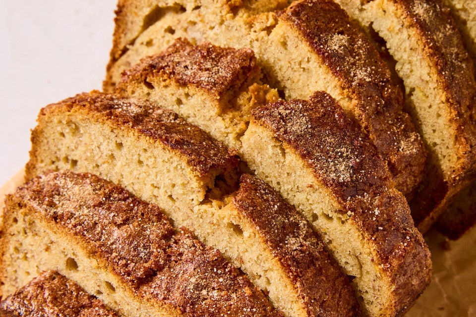 Detail photograph of slices of High-Altitude Banana Bread showing a dark exterior and golden interior.