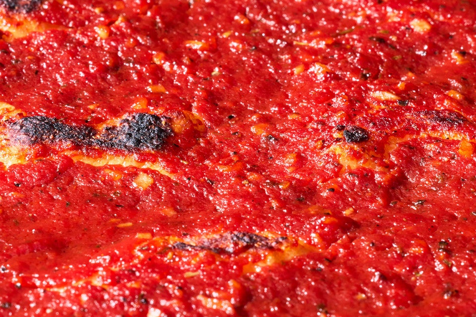 Detail shot of tomato topping on Rhode Island Pizza Strip.