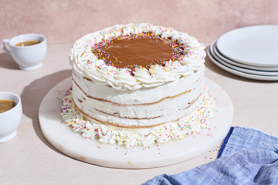 A simple and elegant decorated Torta Chilena with white creme fraiche frosting and dulce de leche on top.