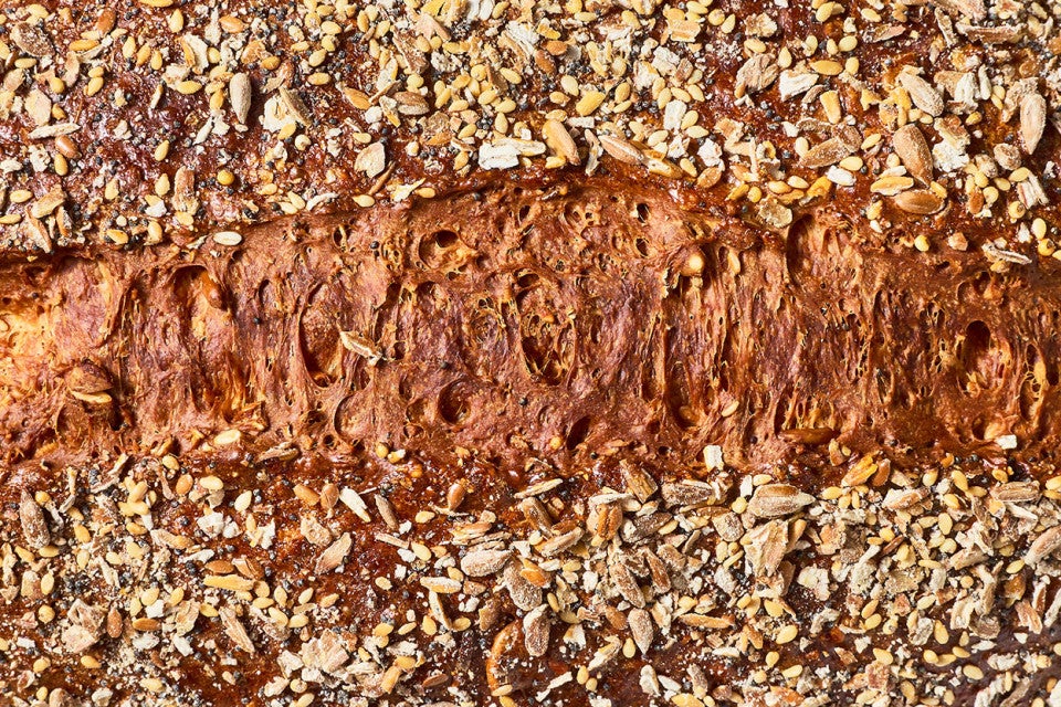 Top view of Multigrain Protein Bread with seeds and a deep brown crust.