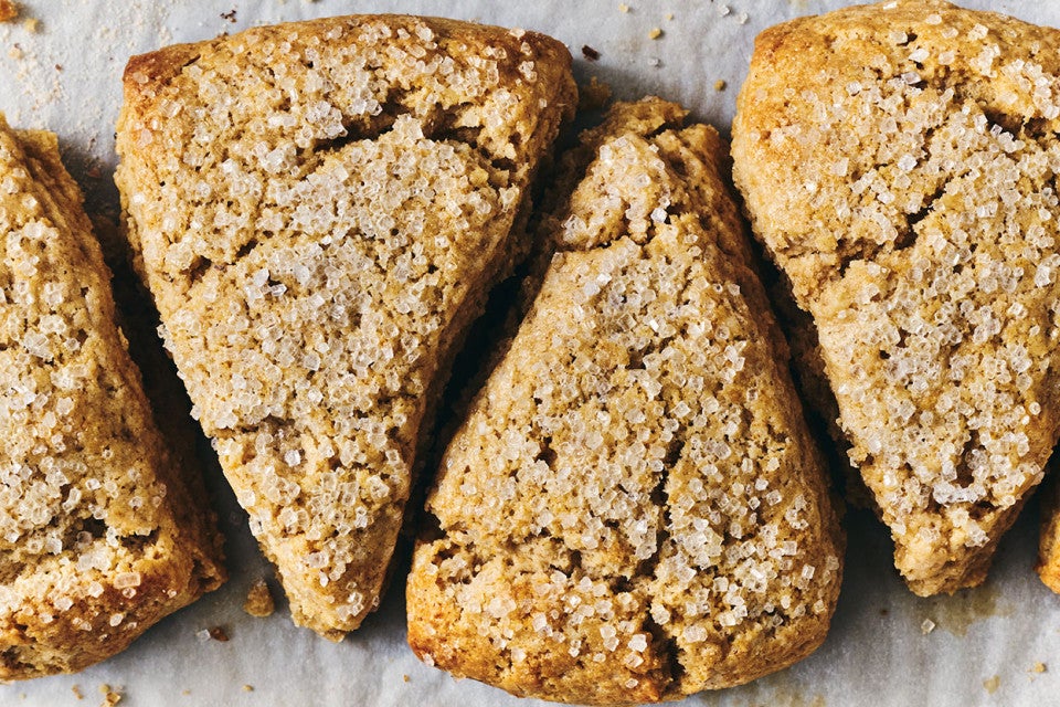4 Golden Wheat Scones arranged in a pattern on parchment paper.