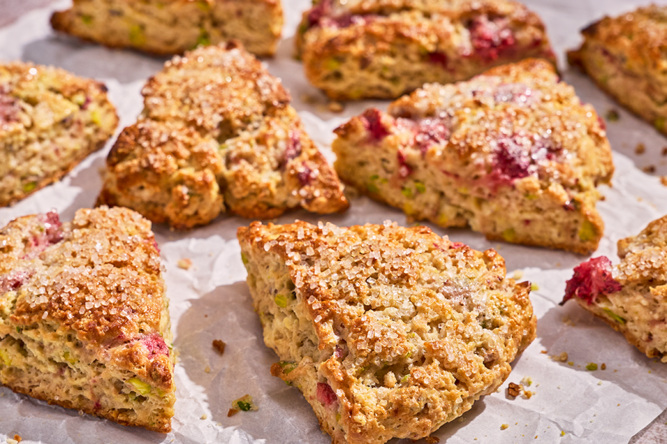 Roasted Strawberry and Pistachio Scones on a baking sheet fresh out of the oven.