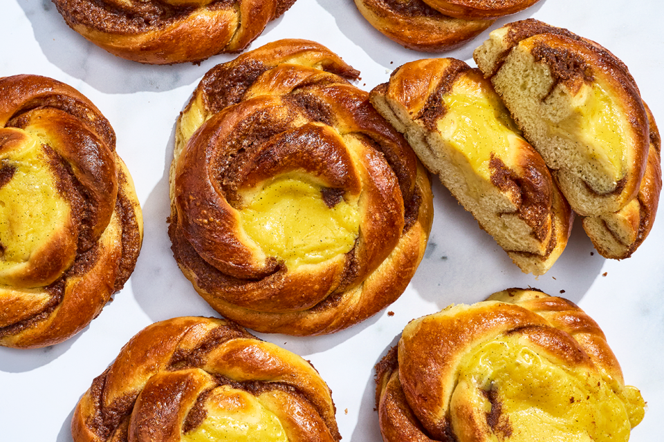 Sunshine Buns seen from above with custard in the center of a baked, braided roll.