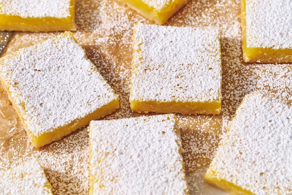 Gluten-Free Lemon Squares with an Almond Flour Crust on parchment.