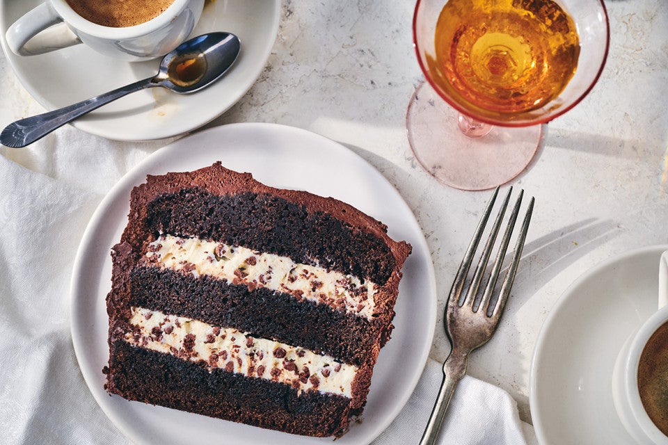 A slice of chocolate cassata cake with layers of chocolate and creamy filling.