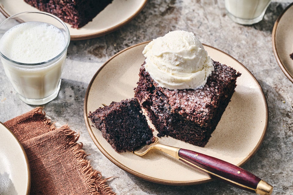 Chocolate Olive Oil Cake topped with vanilla ice cream and a bite on a fork.