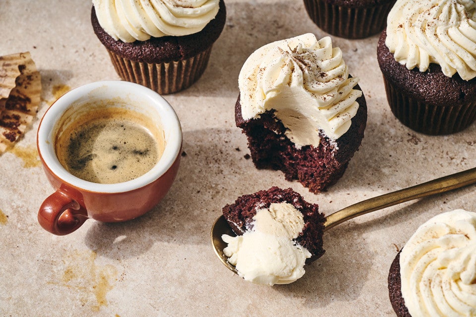 Irish Cream Cupcakes seen from above with a spoonfull of cupcake and frosting in the photo.
