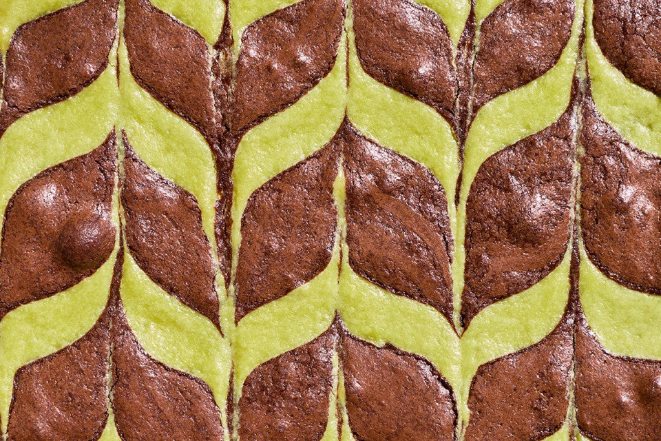 Detailed overhead shot of mint brownies showing a minty feathered pattern.