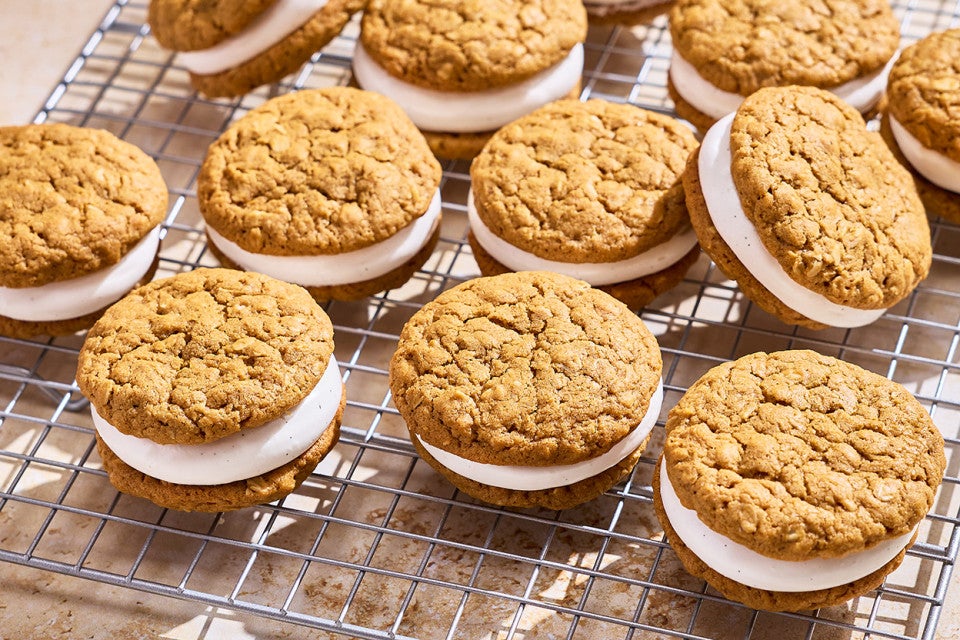 Several oatmeal cream pies on a cooling rack.