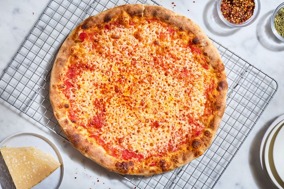 New York-Style Pizza on a cooling rack shown from above.