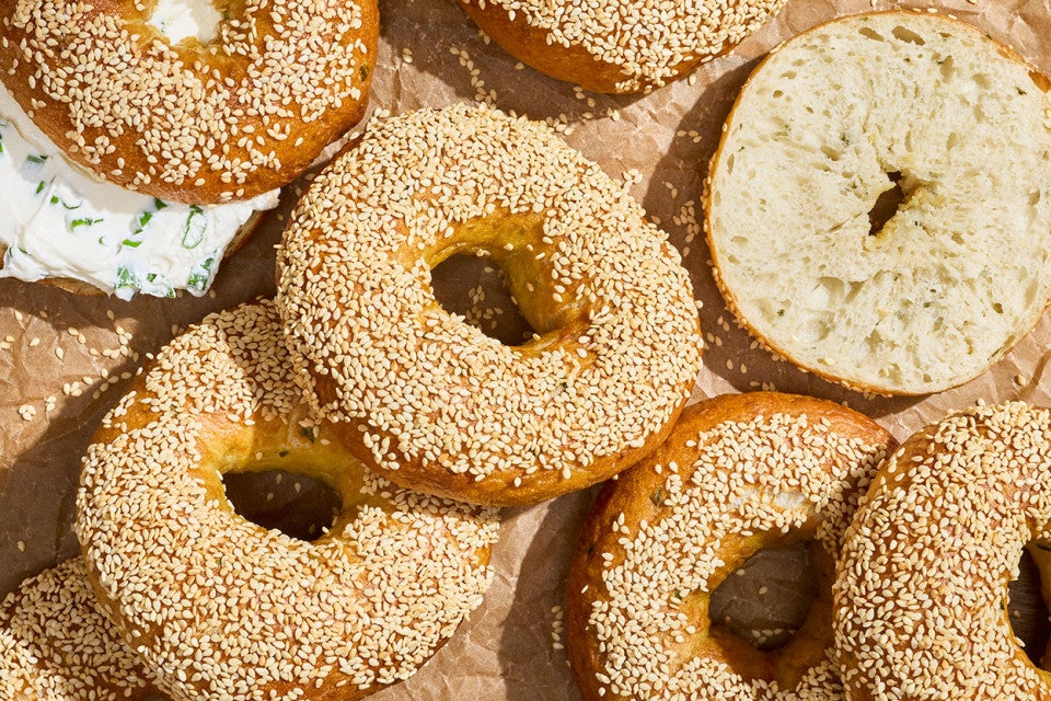 Sesame Sourdough Discard Bagels arrange on a counter and seen from above.