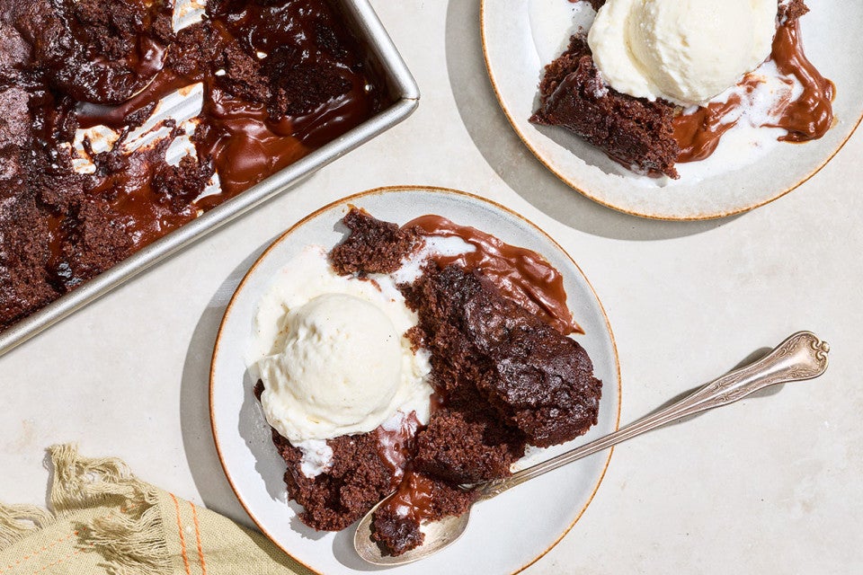 Sourdough Discard Chocolate Pudding Cake on plates with vanilla ice cream.