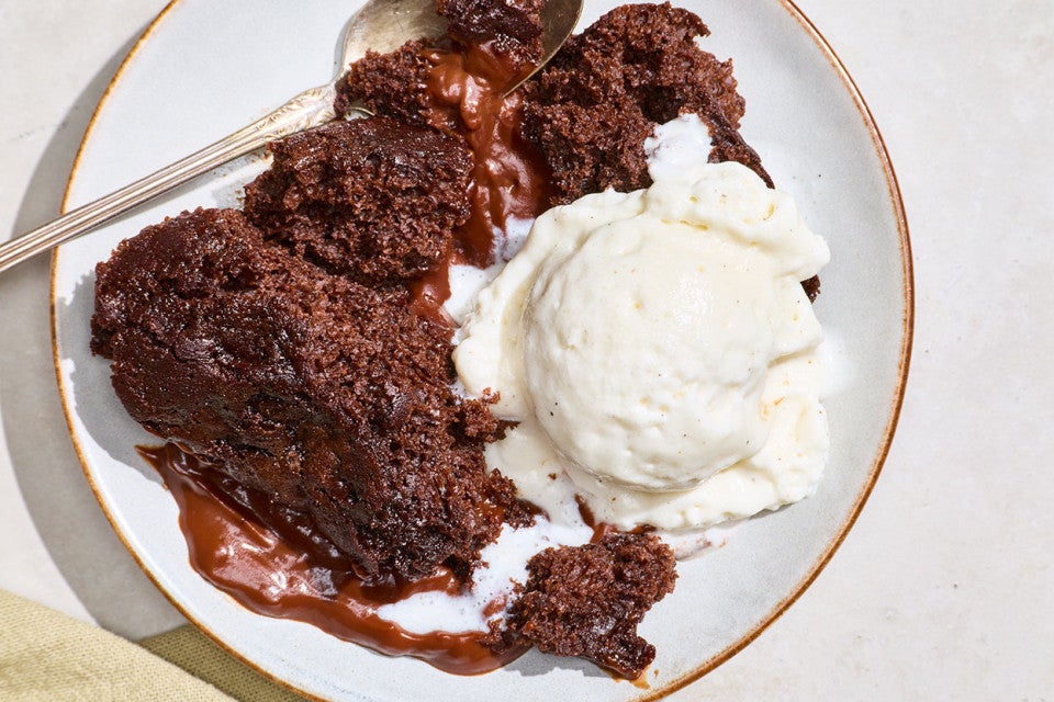 Sourdough Discard Chocolate Pudding Cake on a plate with vanilla ice cream.