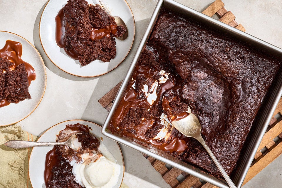 Sourdough Discard Chocolate Pudding Cake in a baking pan and on plates seen from above.
