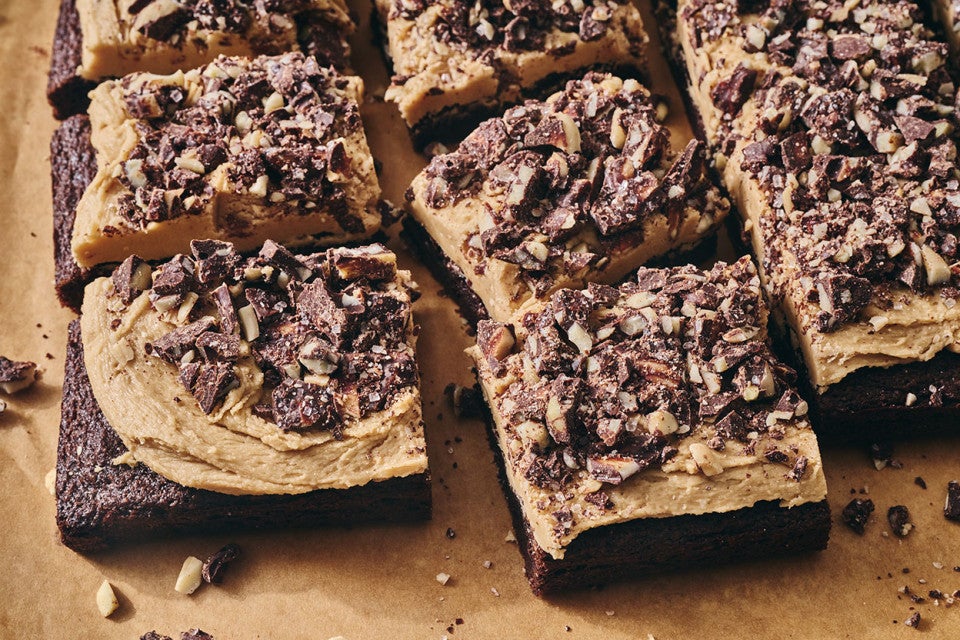Chocolate Caramel Almond Crunch Brownies sliced and photographed on a counter.