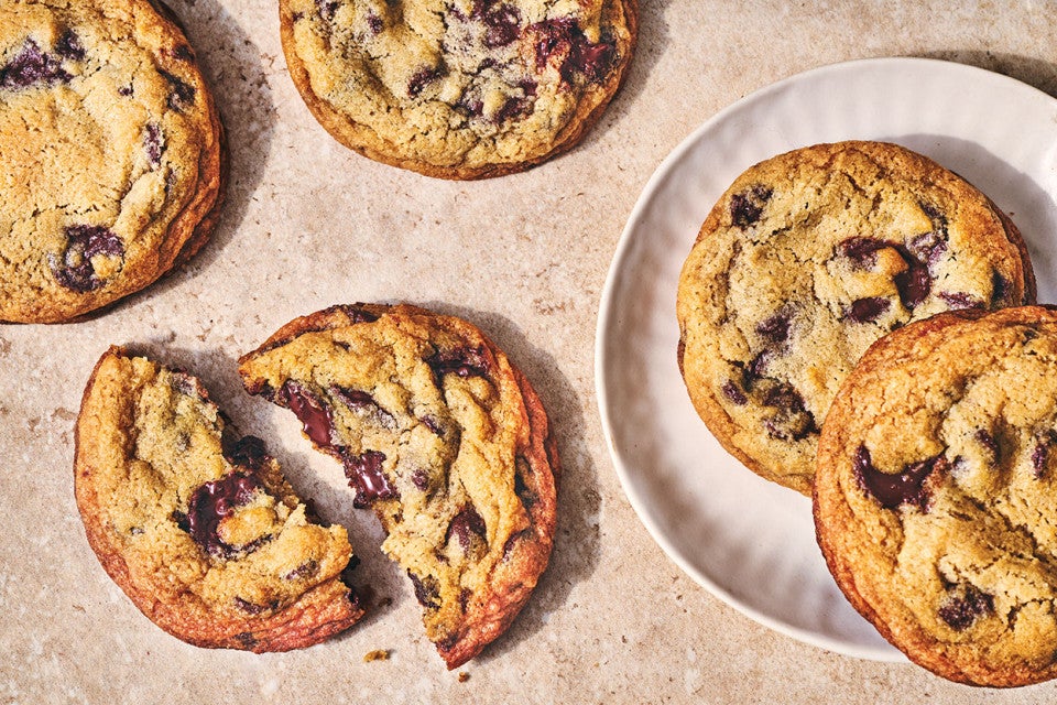 Classic Chocolate Chip Cookies spread out on a countertop.