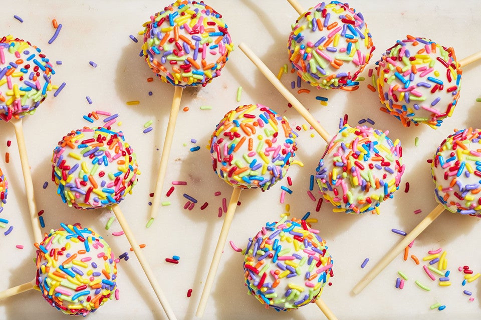 Confetti Cake Pops on a countertop seen from above.
