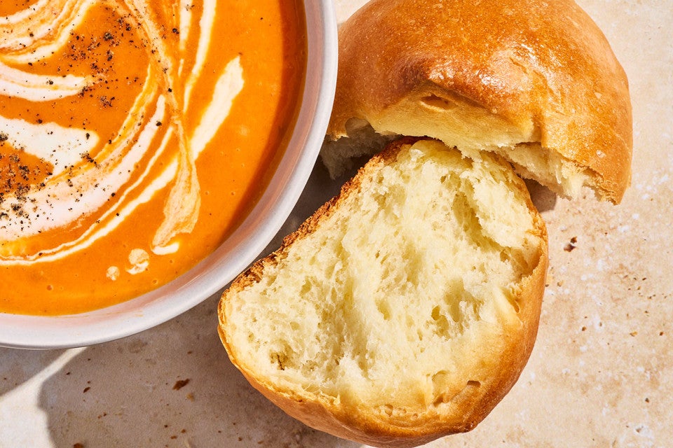 A Soft Golden Bun split apart to show the moist and bready interior.