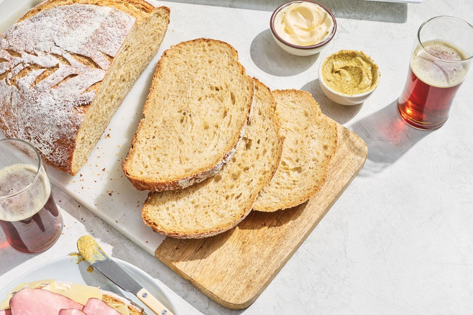 Sourdough Beer Bread sliced on a cutting board.