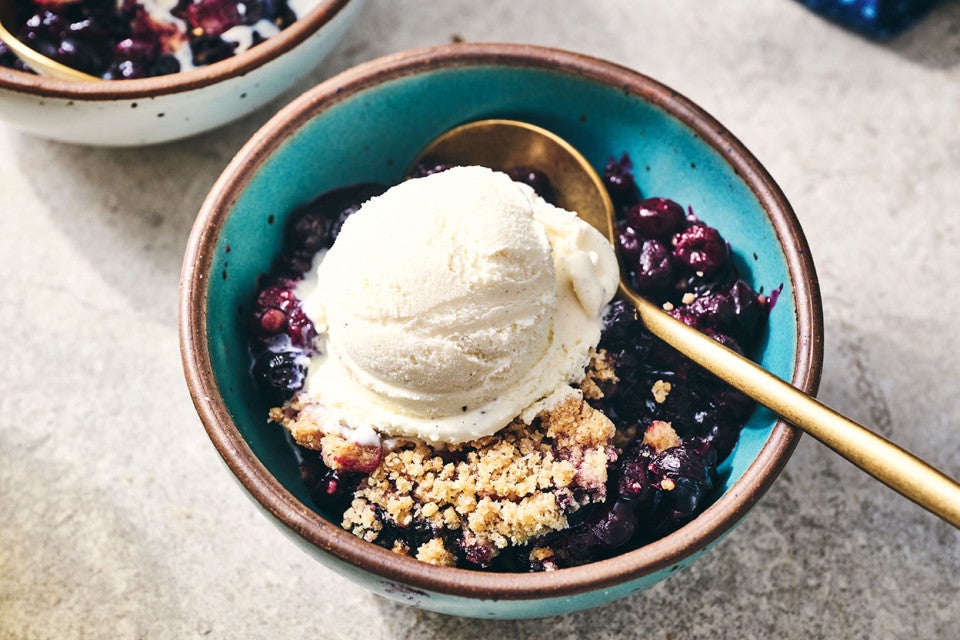 Blueberry Crisp topped with vanilla ice cream in a blue bowl