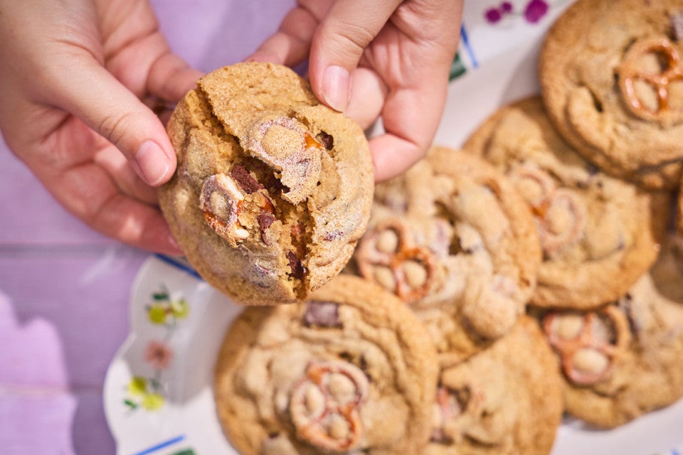 Breaking a Malted Peanut Butter Chocolate Chip Cookie to show the interior