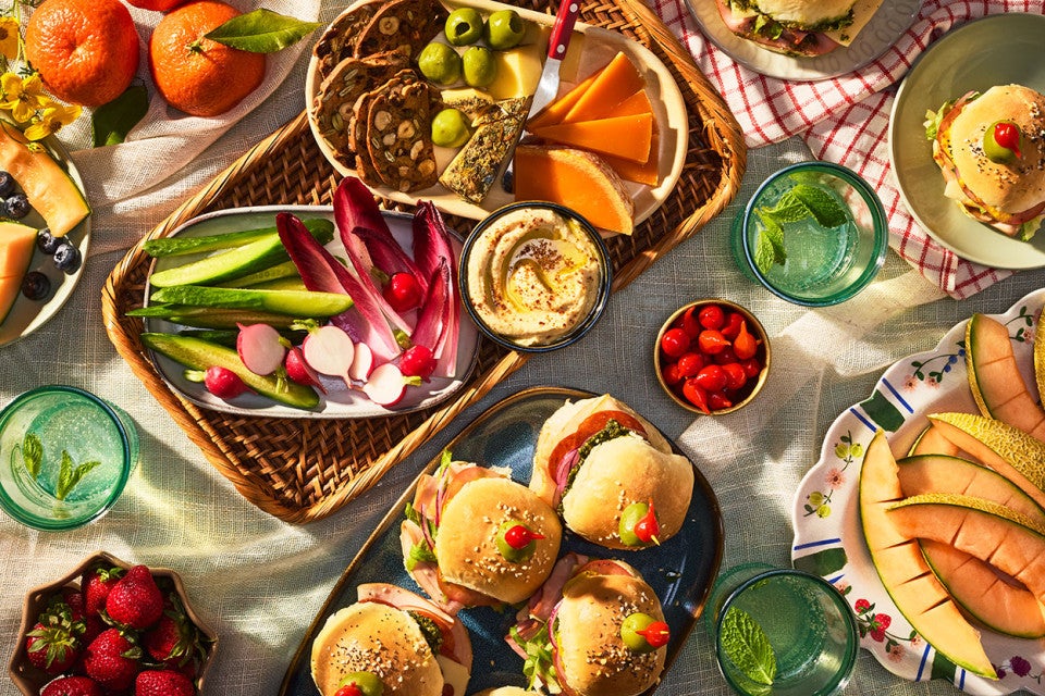 Hot Party Sandwiches on an elaborate table with other vegetables, dips, and lunch items