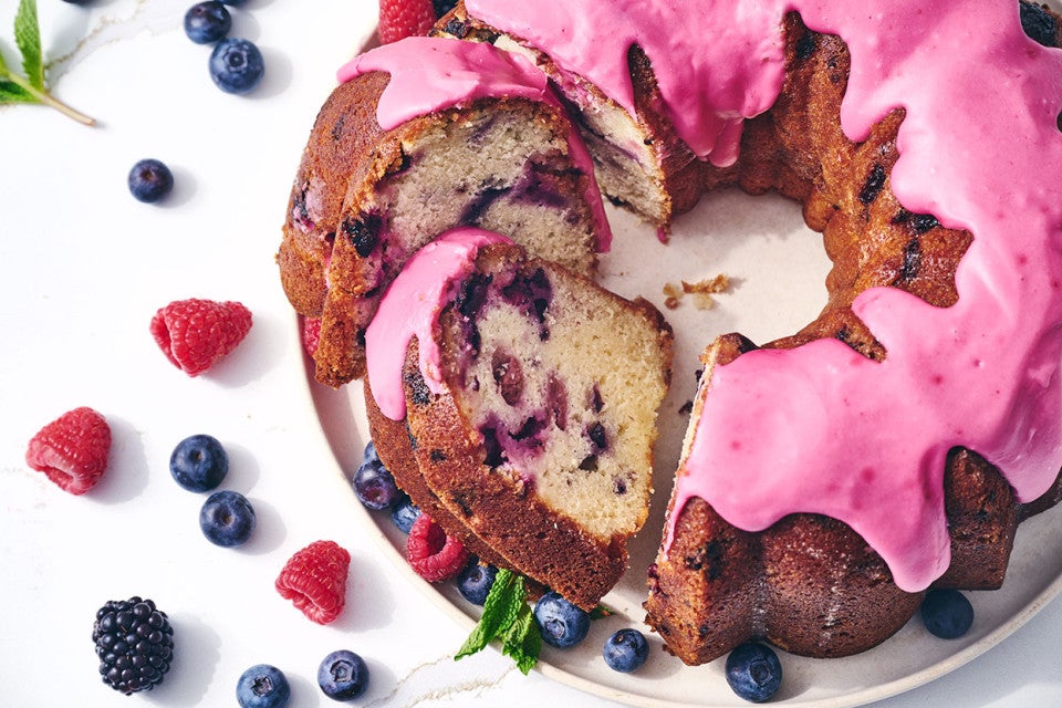 Berry Bliss Bundt Cake sliced and showing a beautiful pink glaze covering the cake