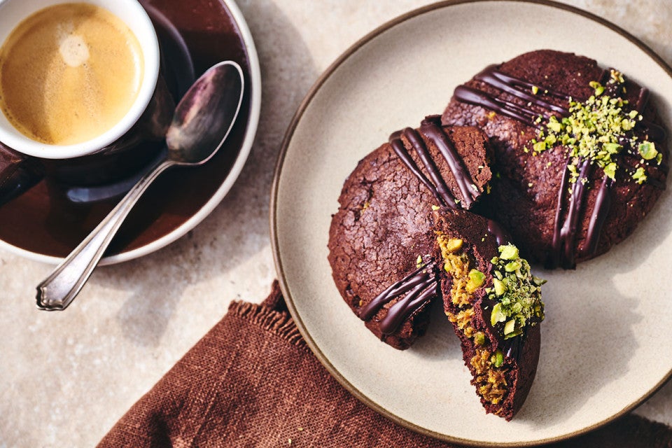 Dubai Chocolate Cookies on a plate with a cup of coffee