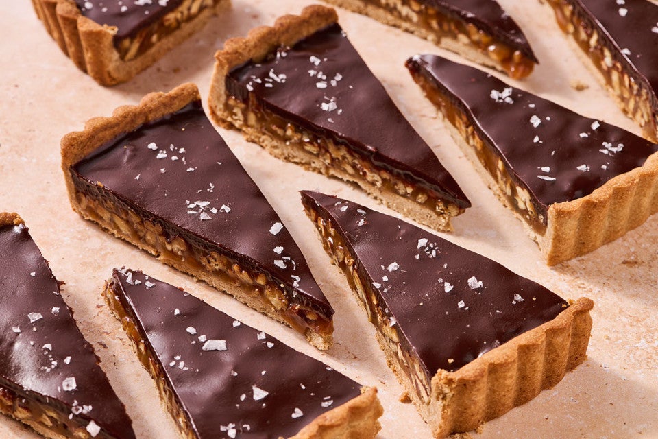 Slices of Candy Bar Pecan Tart arranged neatly on a counter