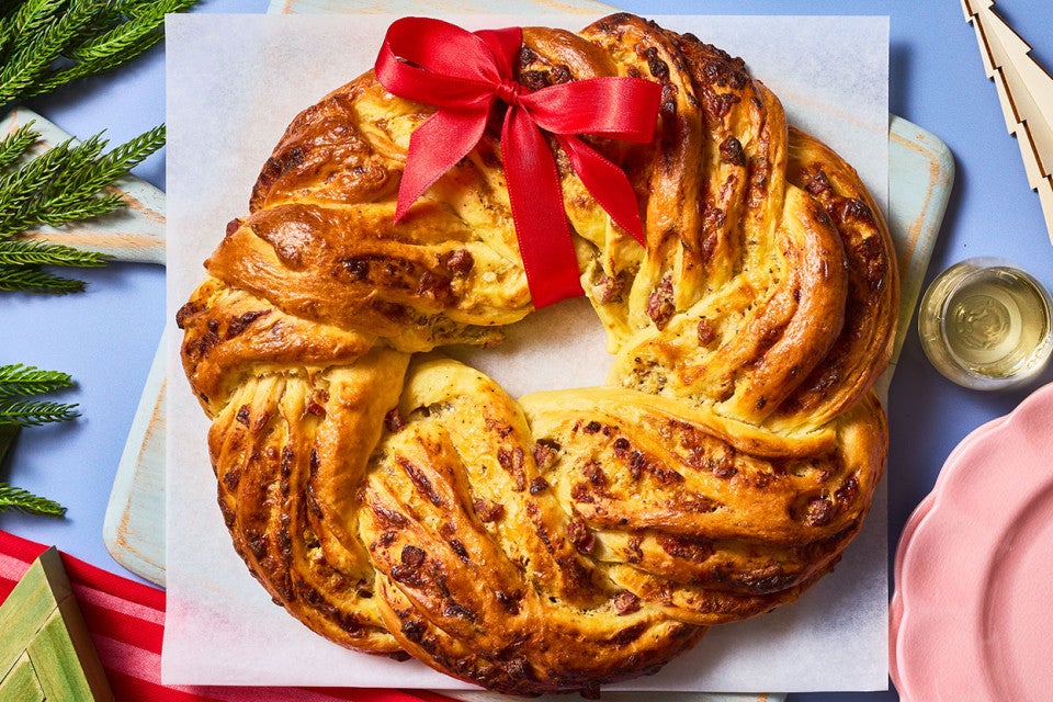 Italian Herb & Cheese Wreath on a cutting board seen from above.