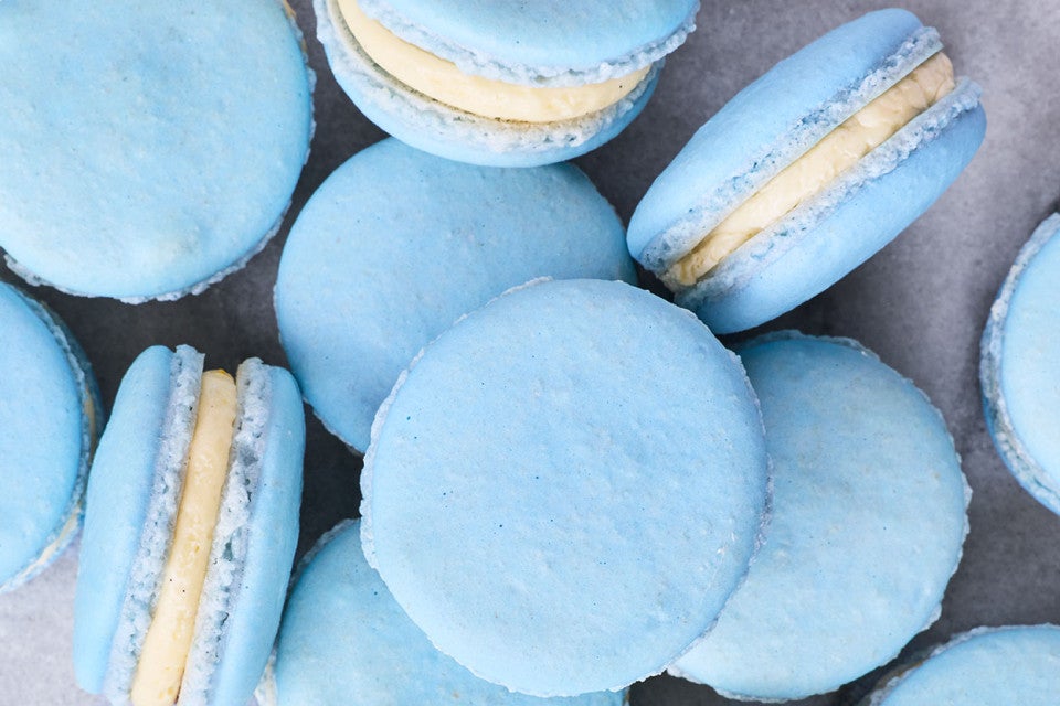 Blueberry macarons arranged on a counter and seen from above.