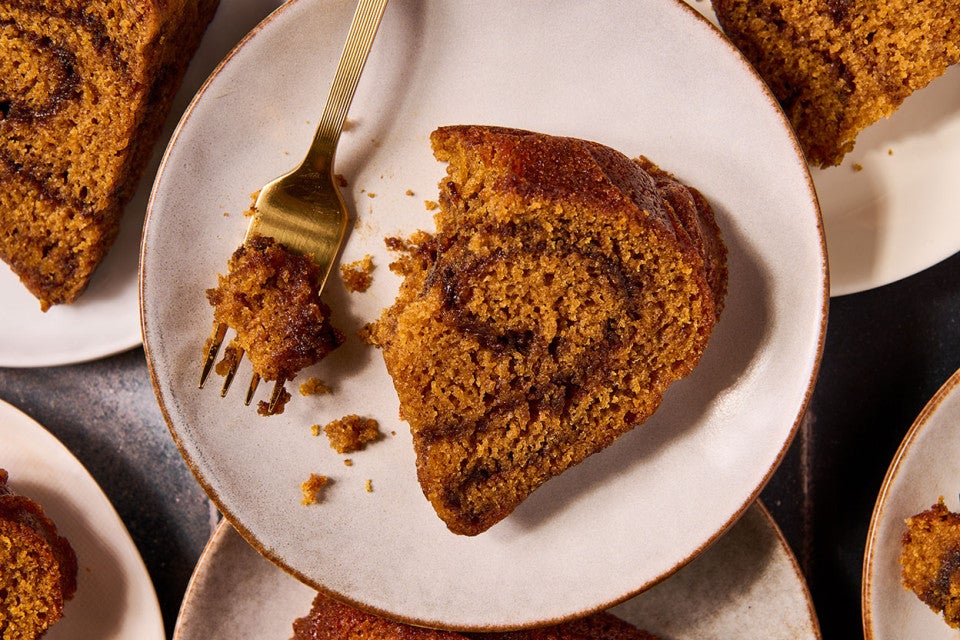 A slice of Pumpkin Espresso Bundt Cake on a plate with a bite on a fork