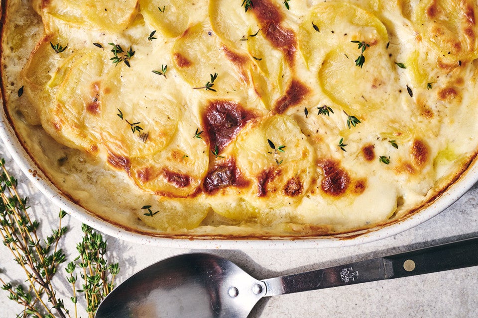 Scalloped Potatoes fresh out of the oven in a stoneware pan seen from above