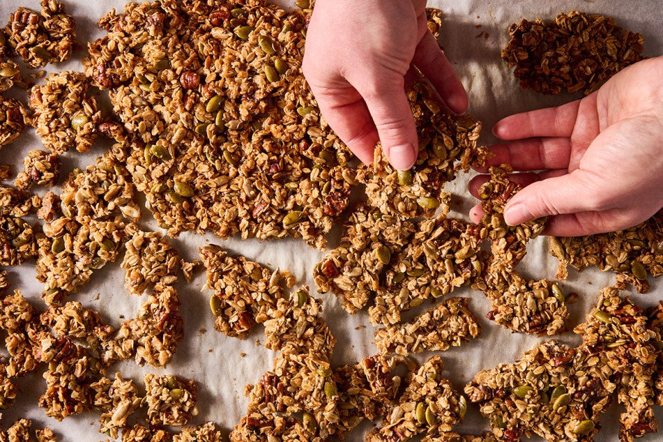Breaking Sourdough Granola apart fresh out of the oven