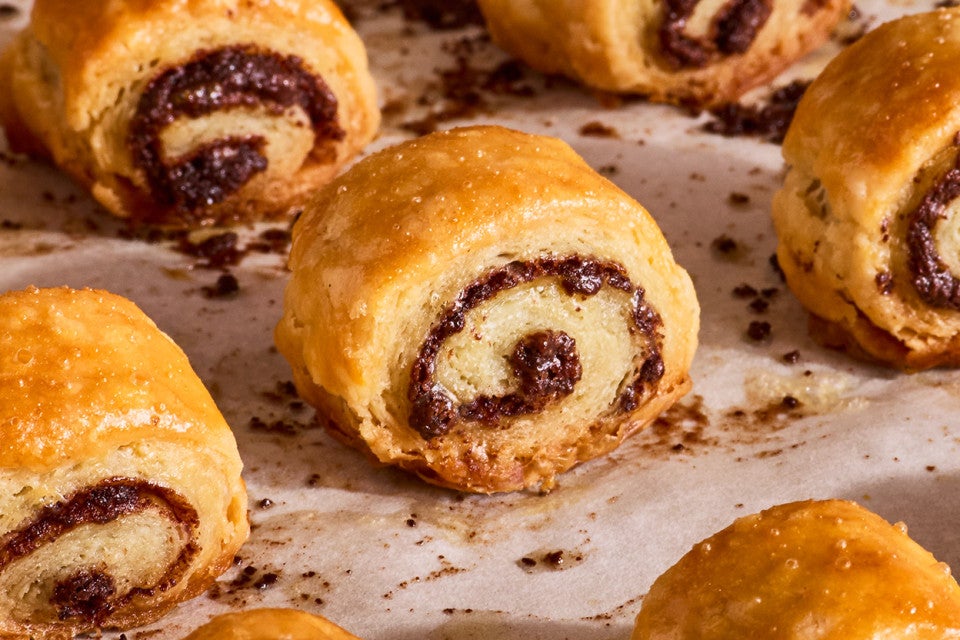 Close up of Chocolate Croissant Cookies on parchment fresh out of the oven