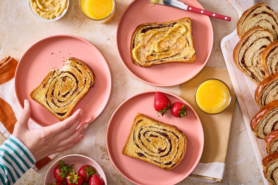 Slices of Sourdough Cinnamon Swirl Bread arranged on plates and seen from above