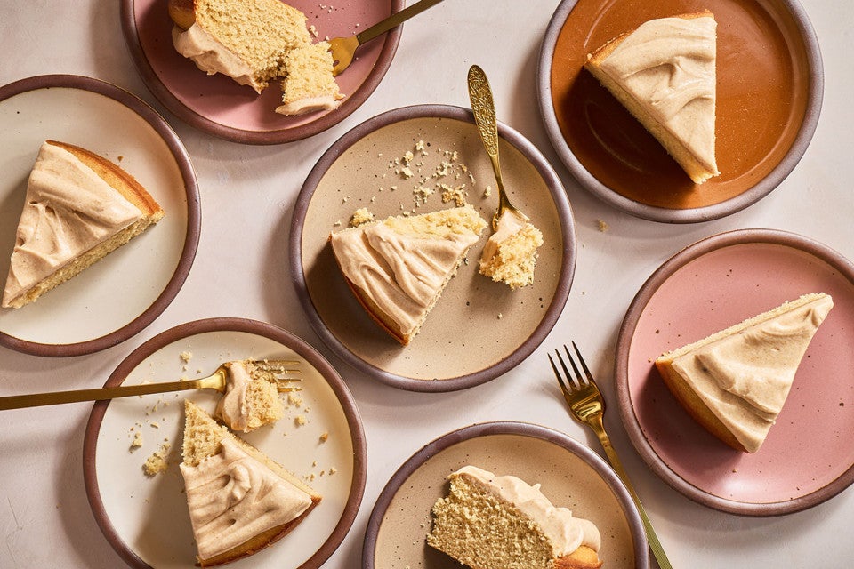 Slices of Frosted Brown Butter Cake on a variety of plates seen from above