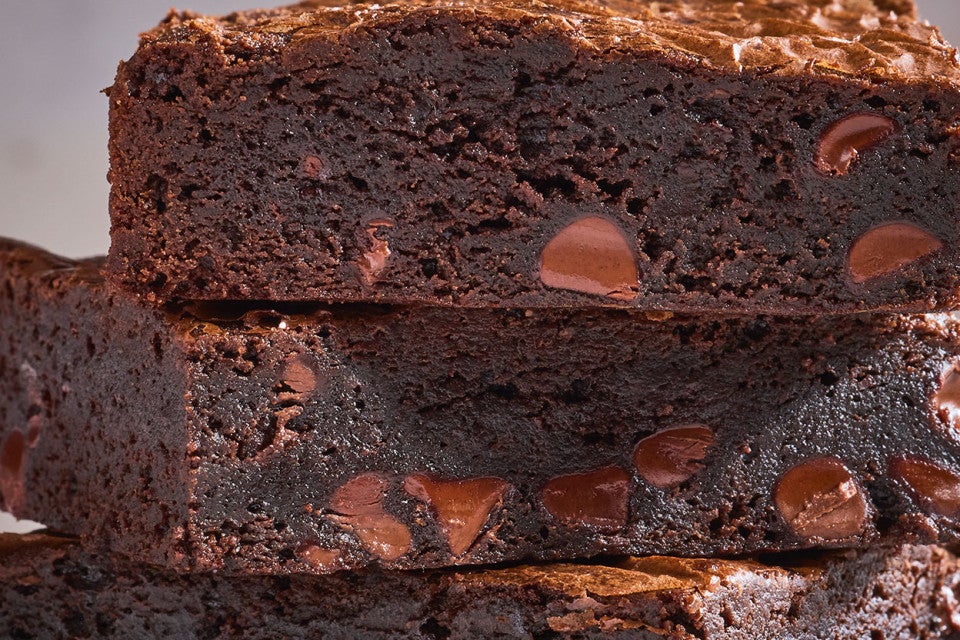 Fudge Brownies stacked together and seen from the side.