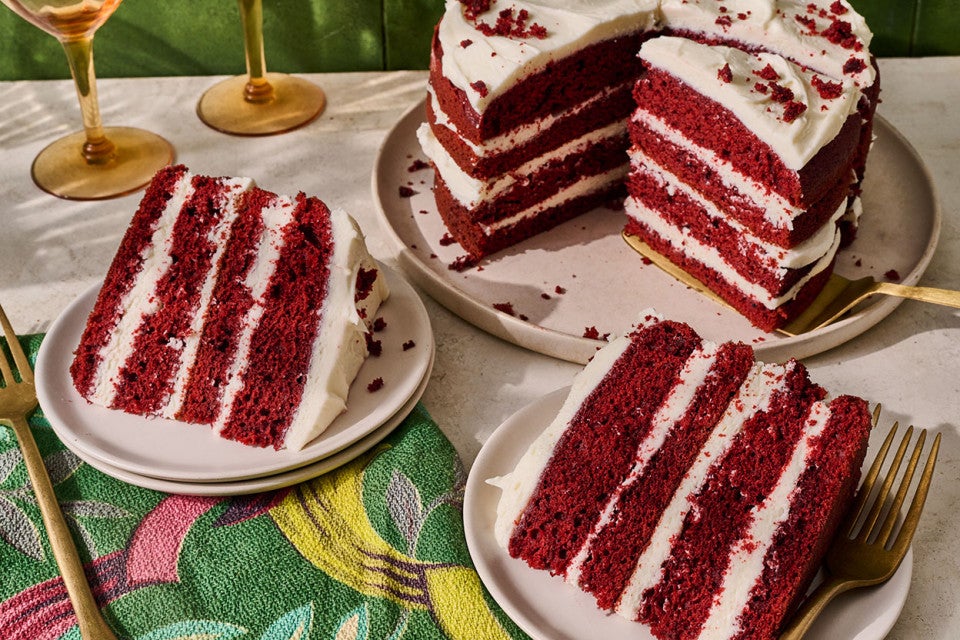 Slices of layered Red Velvet Cake on plates