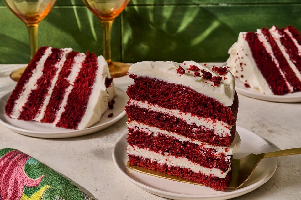 Slices of layered Red Velvet Cake on plates