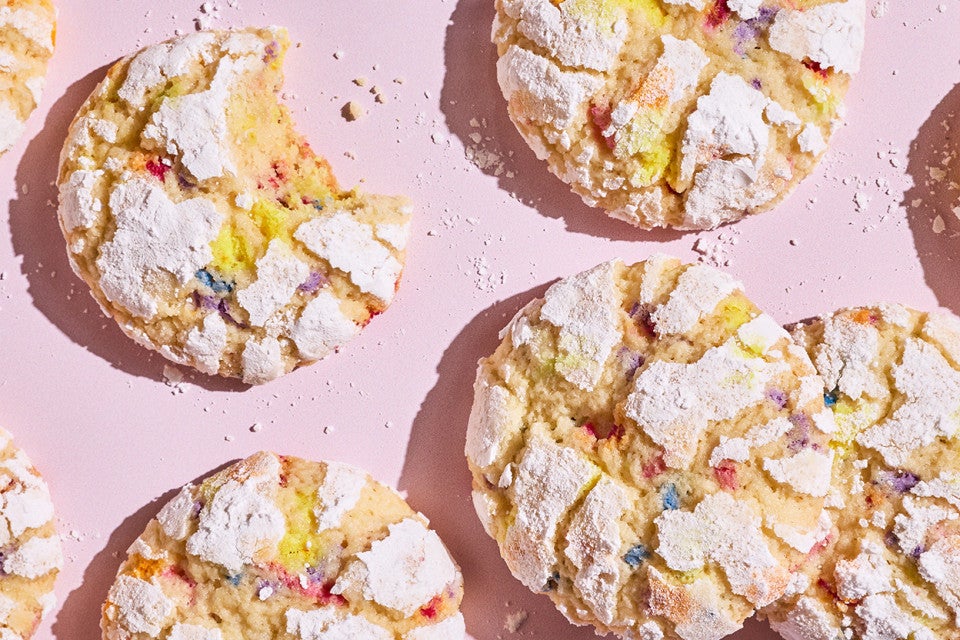 Sprinkle Crinkle Cookies arranged on a light lavender background