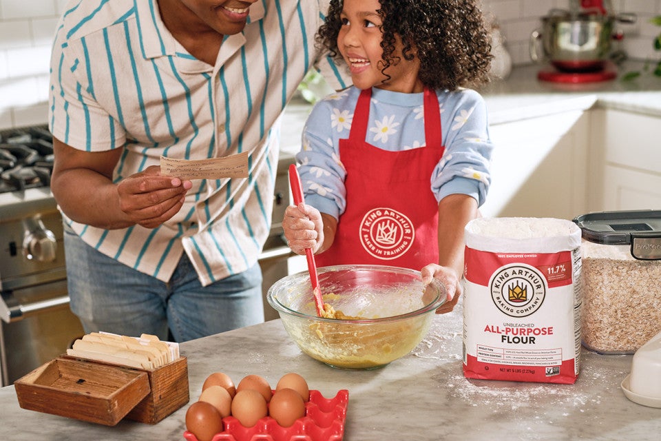 A father and son making oatmeal chocolate chip cookies
