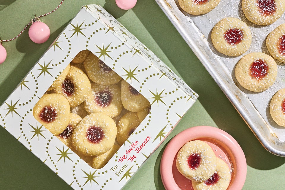 Almond Thumbprints in a gift box, a plate, and on a baking sheet